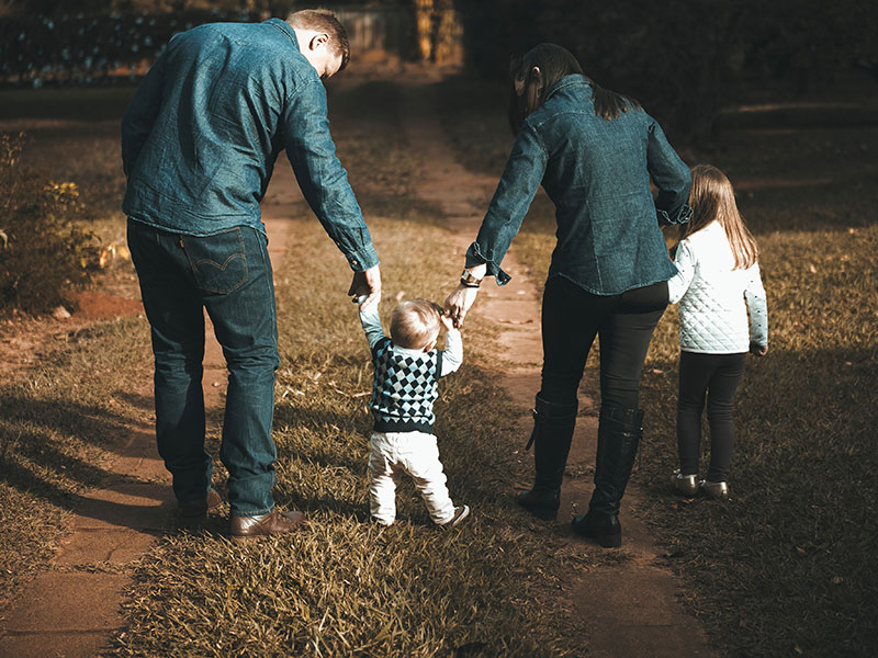 young family walking with their children