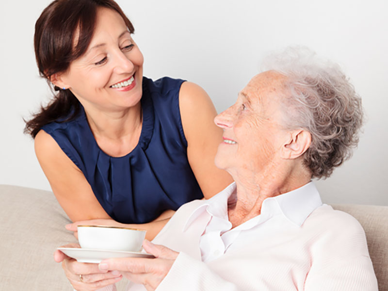 smiling caregiver and older woman