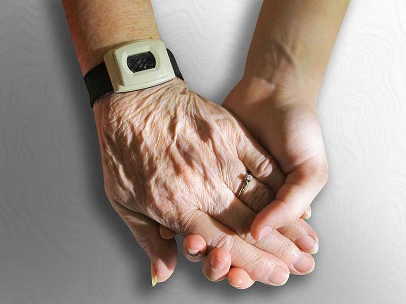 holding a senior person's hand